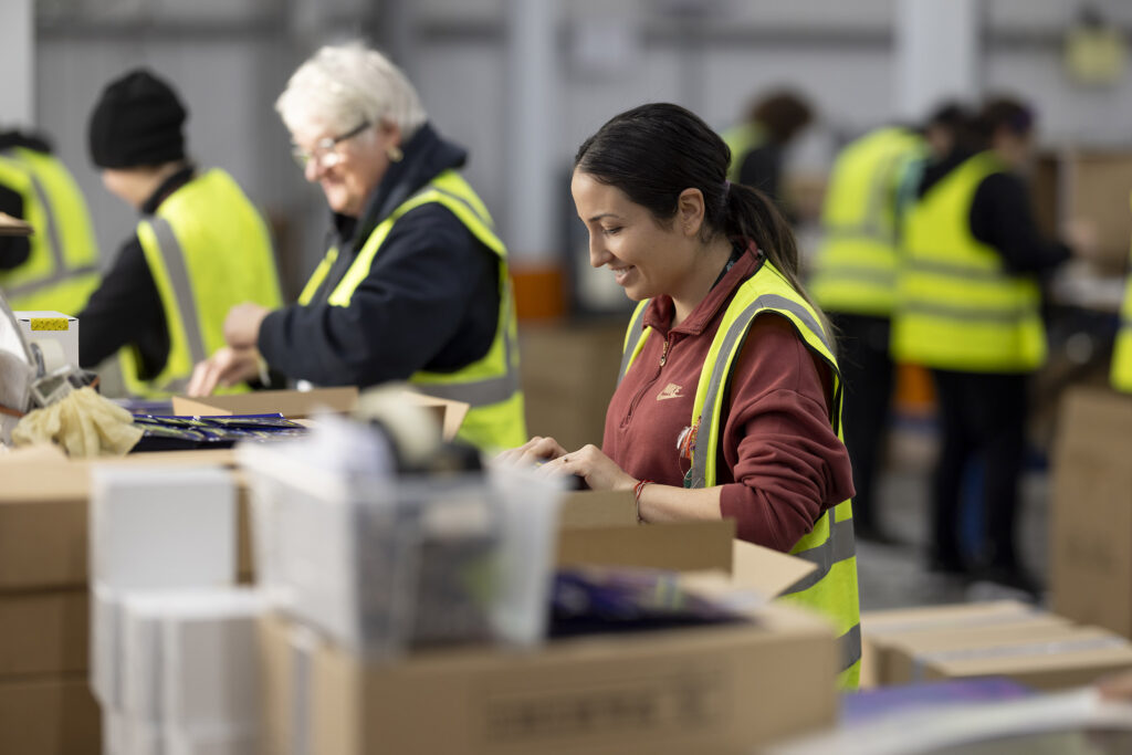 Supporting NHS Supply Chain: 30,000+ Kits Assembled for Pioneering Generation Study 3 Workers at a bench doing contract packing