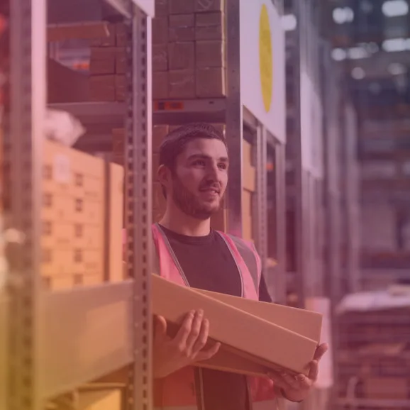Staff member holding parcels with a coloured overlay