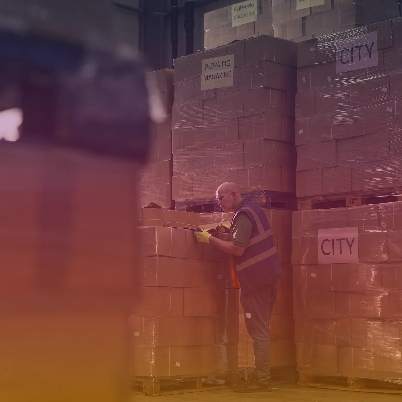 Staff member surrounded with pallets with a coloured overlay