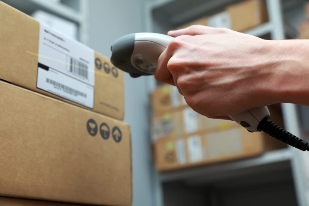 Picture of a closeup of someone scanning a barcode on a box